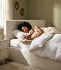 The Hampstead white boucle ottoman storage bed with gas-lift base open showing 610 litre storage – Comfort Crest